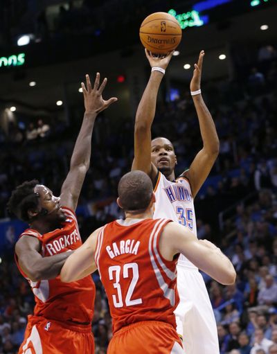 Oklahoma City forward Kevin Durant soared over Houston’s defenders for 42 points in 106-98 win. (Associated Press)