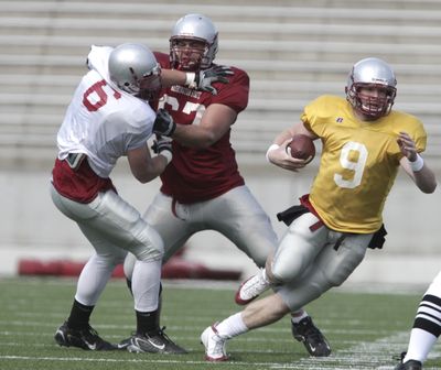Washington State quarterback Kevin Lopina looks for running room as Joe Eppele blocks Cory Mackay, left. Special to  (Tyler Tjomsland Special to / The Spokesman-Review)