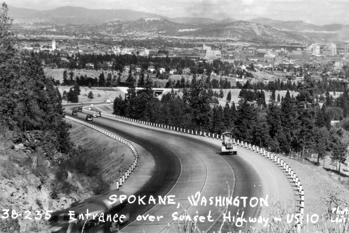 This postcard from 1938 shows traffic on Sunset Hill, the western entrance to Spokane proper. During this era, traffic from Seattle followed what is now Highway 2. Photo from The Northwest Room, Spokane Public Library. (Northwest Room / Northwest Room)