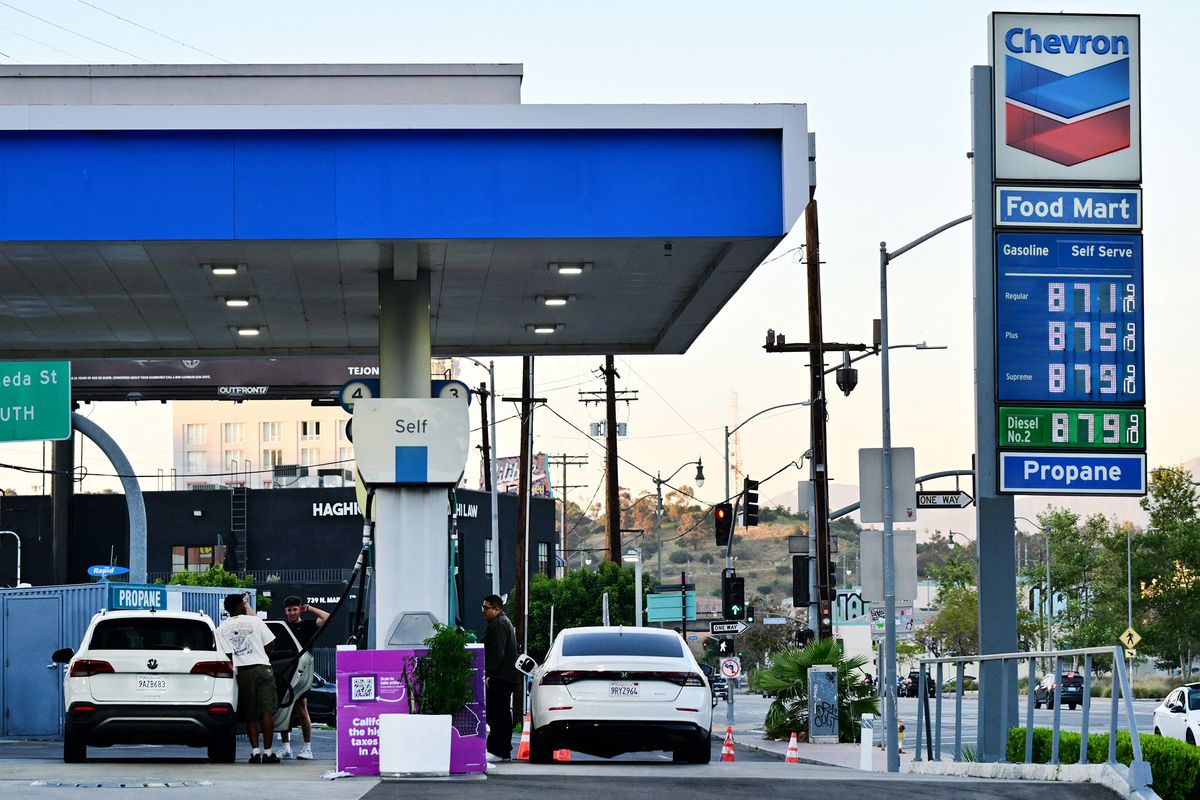 The sign of a Chevron gas station displays current prices as drivers pump gas in Rosemead, near Los Angeles, on March 18, 2026. Oil prices surged March 18 following a strike on a major Iranian gas facility as the Federal Reserve raised its inflation forecast while holding interest rates steady. (Frederic J. Brown/AFP/Getty Images/TNS) (Frederic J. Brown/AFP/GETTY IMAGES NORTH AMERICA/TNS)