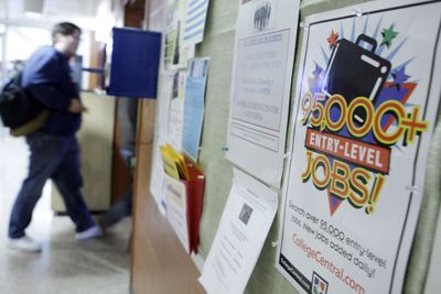 A student walks past a job board at Harrisburg Area Community College in Harrisburg, Pa., on Friday. The nation’s unemployment rate has risen to 6.1 percent, up from 4.7 percent a year ago.  (Associated Press / The Spokesman-Review)