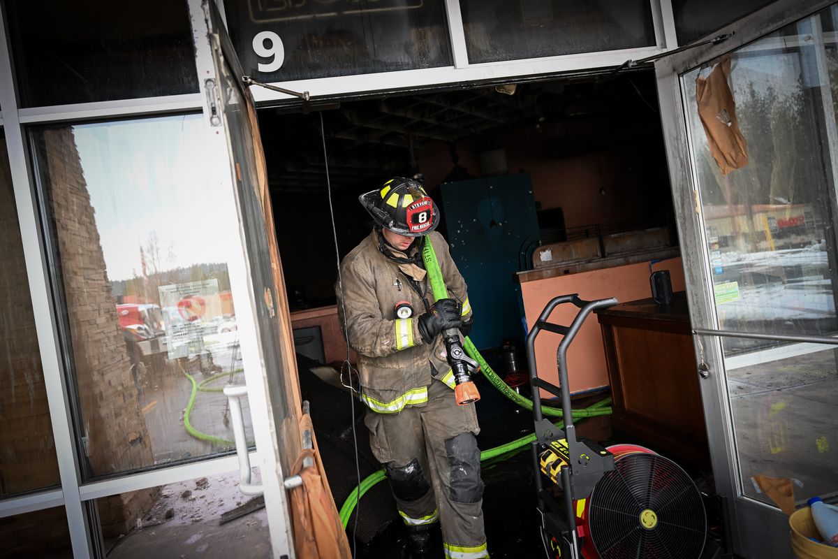 Crews work to clean up a structure fire at the site of the former El Ranchito Mexican restaurant on Friday at 5919 WA-291, Nine Mile Falls, Wash.  (Tyler Tjomsland/The Spokesman-Review)