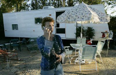 
Janet Kisling checks with friend outside her FEMA trailer in Ocean Springs, Miss., earlier this week. Starting on Dec. 15, she will be paying a mortgage on her home destroyed by Hurricane Katrina. 
 (Associated Press / The Spokesman-Review)