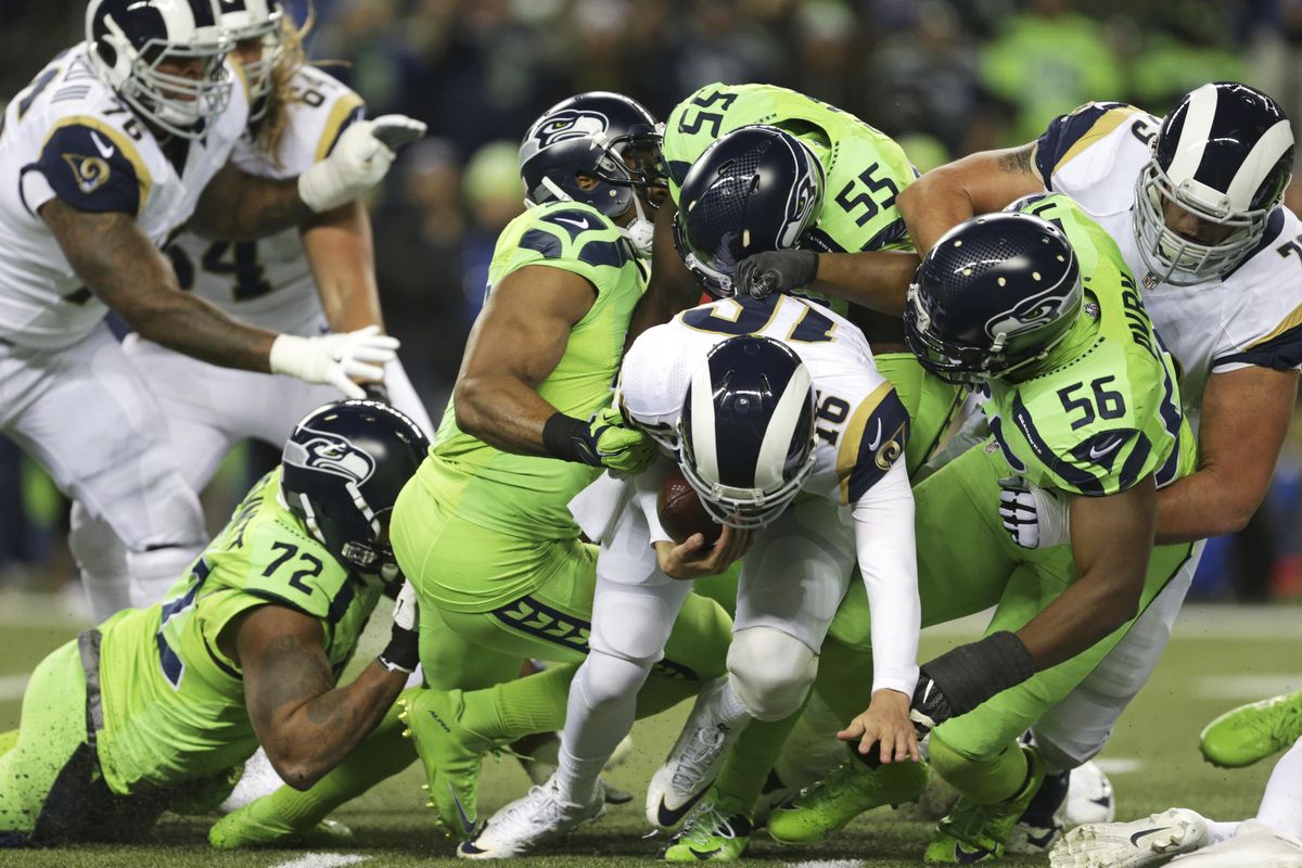 Los Angeles Rams quarterback Jared Goff (16) is sacked by Seattle Seahawks’ Cliff Avril (56), Frank Clark (55), and Bobby Wagner, second from left, in the first half of an NFL football game, Thursday, Dec. 15, 2016, in Seattle. (Scott Eklund / Associated Press)