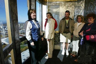 
Jenny Dibley, left, rides the elevator at the Space Needle in Seattle, with visitors Tuesday. On Wednesday, Dibley marked 30 years operating elevators at the Space Needle by doing what she does best, going up and down, up and down, all day, entertaining visitors along the way. 
 (Associated Press / The Spokesman-Review)