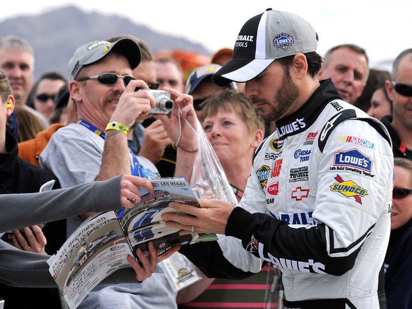 Four-time NASCAR Sprint Cup Series champion Jimmie Johnson signs autographs for fans during qualifying for the NASCAR Sprint Cup Series Shelby American at Las Vegas Motor Speedway. (Photo courtesy of John Harrelson for Getty Images/NASCAR)