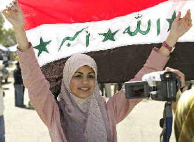 
Iraqi immigrant Marwa Sadik of Seattle celebrates before voting in Irvine, Calif., on Saturday. 
 (Associated Press / The Spokesman-Review)