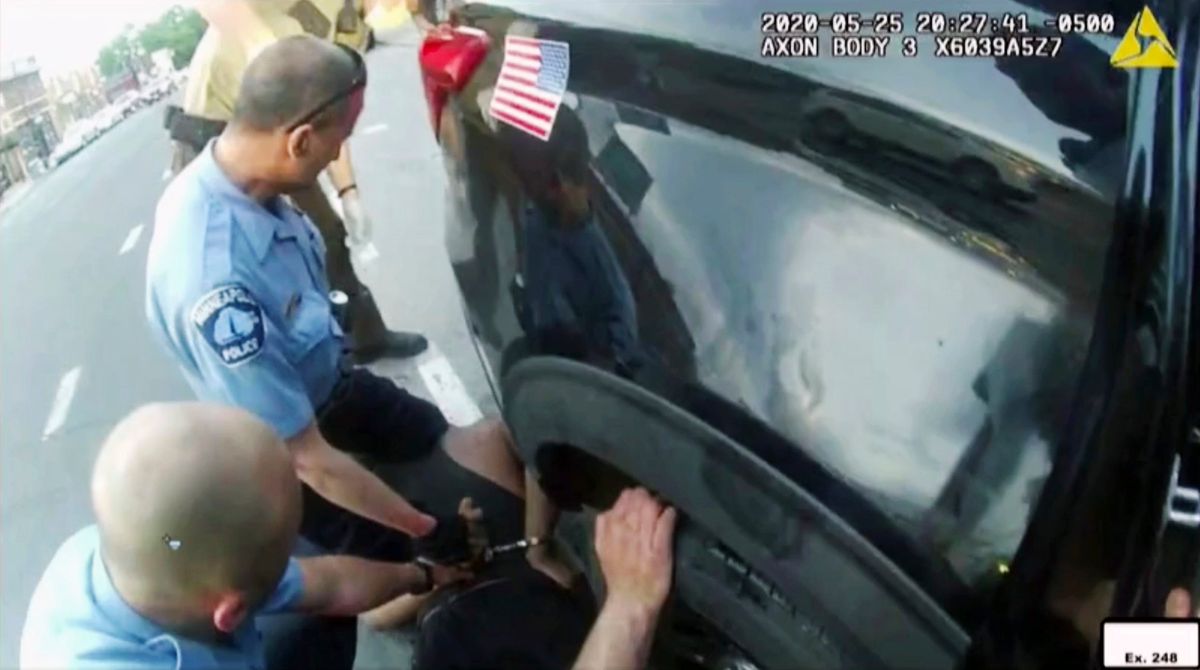 In this image from police body camera video shown as evidence in court, paramedics arrive as Minneapolis police officers, including Derick Chauvin, second from left, and J. Alexander Kueng restrain George Floyd in Minneapolis, on May 25, 2020. Former police Officers Tou Thao, Kueng and Thomas Lane are on trial in federal court accused of violating Floyd