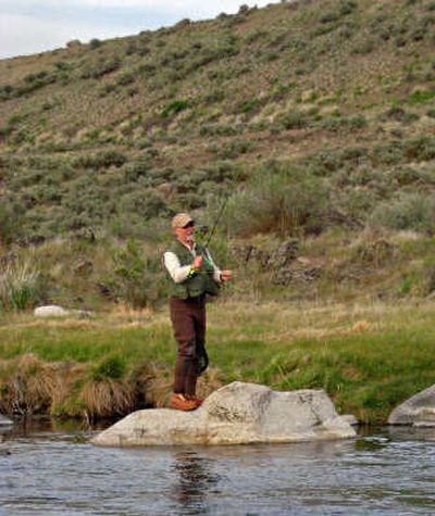 
Tacoma News Tribune Mark Miller of Spokane hooked a 28-inch rainbow on Rocky Ford Creek in May.
 (Tacoma News Tribune / The Spokesman-Review)