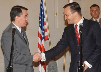 Polish Foreign Minister Radek Sikorski, right, shakes hands with chief U.S. negotiator John Rood after an initial agreement. (Associated Press / The Spokesman-Review)