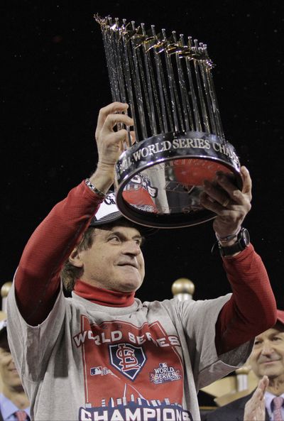In this Oct. 28 photo, St. Louis Cardinals' Tony La Russa holds up the Commissioner's Trophy after Game 7 of baseball's World Series against the Texas Rangers,  in St. Louis. Three days after winning the World Series,  La Russa is retiring. The 67-year-old manager announced his retirement at a news conference Monday, Oct. 31, 2011 at Busch Stadium in St. Louis. (AP Photo/Charlie Riedel, File)