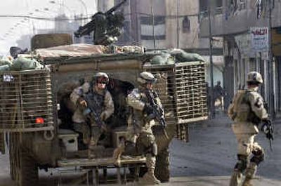 
U.S. Army 1st Battalion, 24th Infantry regiment soldiers emerge from a Stryker combat vehicle during a gunbattle in Mosul in February. 
 (File/Associated Press / The Spokesman-Review)