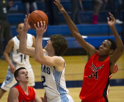 CV's Cameron Tucker looks to shoot between LC’s Justin Martin, left and Naje' Smith on Tuesday. (Colin Mulvany)