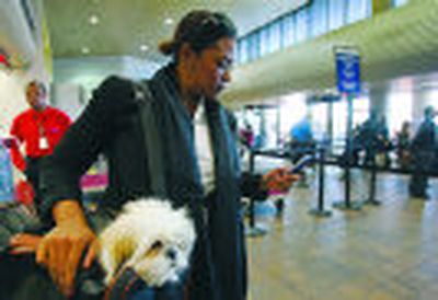 
Milsa Grant of New York holds her dog, Lulu Madonna, as she waits to check in at the Delta terminal at LaGuardia Airport in New York, in this file photo. 
 (Associated Press photos / The Spokesman-Review)
