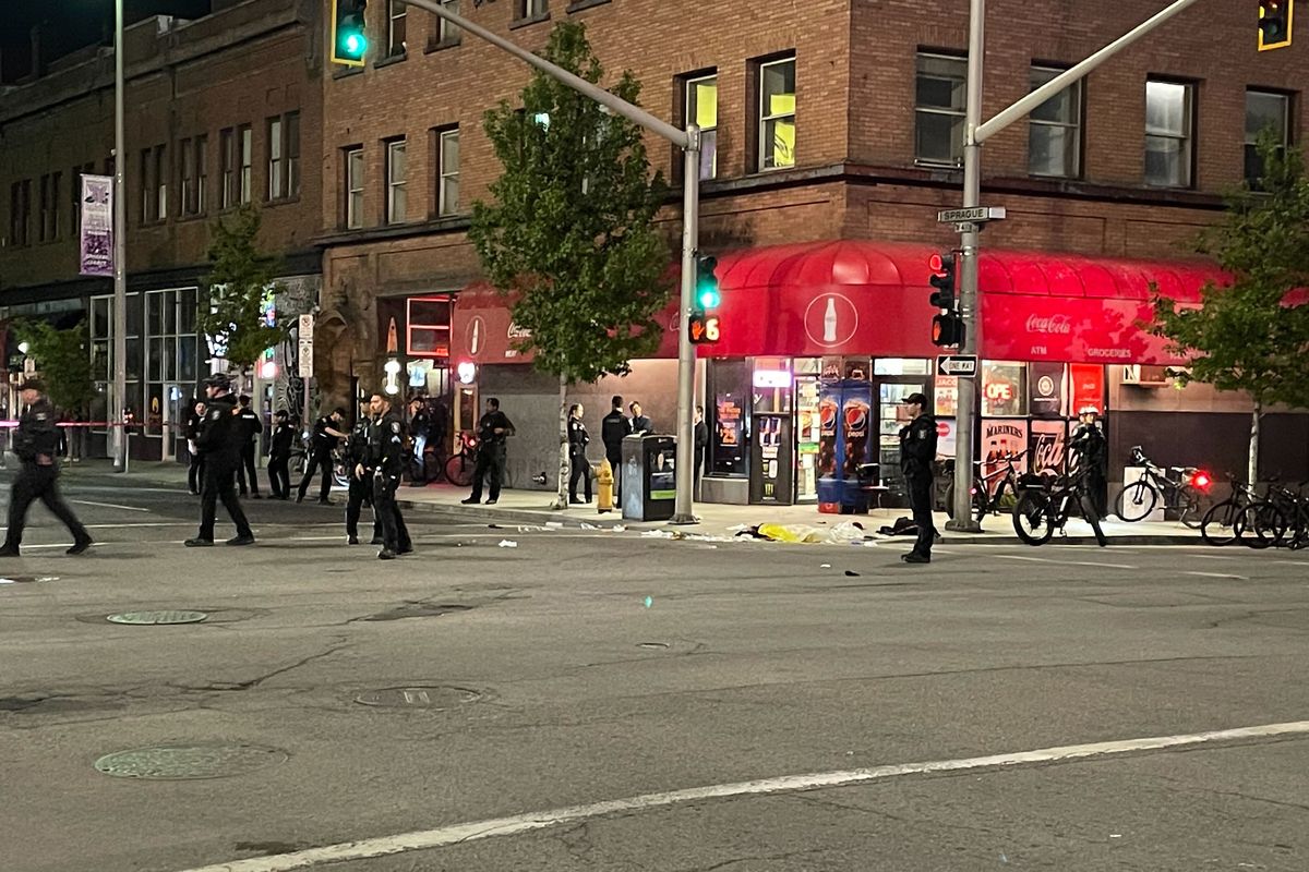 A shooting downtown forced a long pause in the annual Lilac Festival Armed Forces Torchlight Parade late Saturday as police worked to secure the area and emergency crews treated those who were injured.  (Garrett Cabeza/The Spokesman-Review)