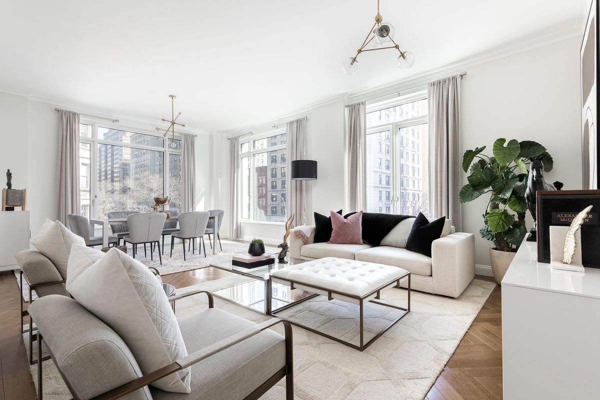 White furnishings including sofa, chairs, ottoman, area rug and sideboard featured through the popular design technique of color mapping, in which color is “mapped” or repeated throughout a space. (Handout/TNS)  (Handout/Cathy Hobbs/TNS)