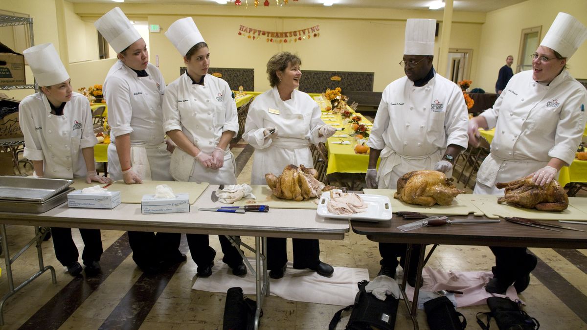 Chef Karen Torkelson (center, no hat), along with a group of volunteers from the Inland Northwest Culinary Academy, spent Nov. 17 carving 20 freshly cooked turkeys in preparation for the Women and Children’s Free Restaurant Thanksgiving Dinner the following day. Culinary students include, from left, Kylsey Pehl, Emily Kern, Amanda Tallman, Sam Powell and Jessica Gonwick.  (Photos by Colin Mulvany / The Spokesman-Review)