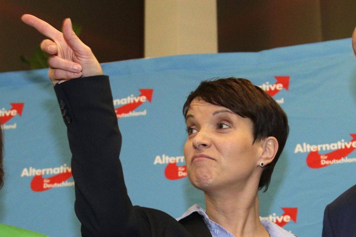Alternative for Germany chairwoman Frauke Petry points at the gathering of the right-populist AfD after the closing of  state elections  in Berlin. (Michael Sohn / Associated Press)