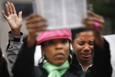 Cynthia Blackledge cries as Brenda Buckner holds up a Bible during a protest of a same-sex marriage bill considered by the District of Columbia Council on Tuesday.  (Associated Press / The Spokesman-Review)