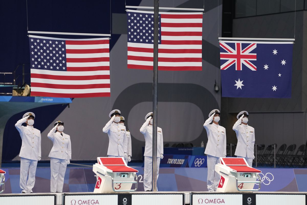 The flags are raised for the medal ceremony for the men’s 400-meter individual medley at the 2020 Summer Olympics on July 25 in Tokyo, Japan.  (Martin Meissner)
