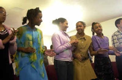 
Children sing along with the opening hymn during the 115th anniversary celebration at Bethel AME Church on Sunday. The church was organized in 1890. 
 (Liz Kishimoto / The Spokesman-Review)