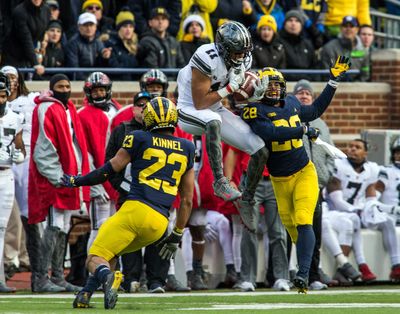 In this Nov. 25, 2017, file photo, Ohio State wide receiver Austin Mack (11) makes a catch defended by Michigan defensive backs Tyree Kinnel (23) and Brandon Watson (28), in the third quarter of an NCAA college football game in Ann Arbor, Mich. The junior was the fifth-leading receiver last year with 24 catches for 343 yards and two TDs. (Tony Ding / Associated Press)