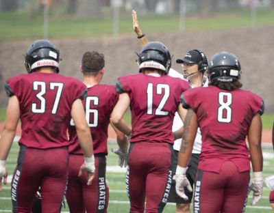 Whitworth head coach Rod Sandberg, hand raised, talks with his defense  during an August scrimmage at the Pine Bowl. (Jesse Tinsley / The Spokesman-Review)