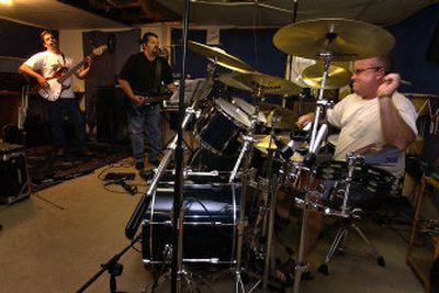 
From left, bassist Sean Bos, lead singer and guitarist Mike Ruscio and drummer Brian Migliore practice one of their songs during an evening practice. 
 (Liz Kishimoto / The Spokesman-Review)