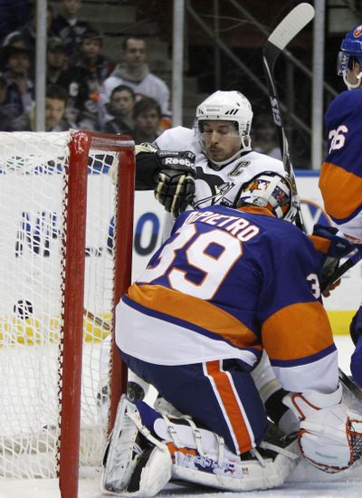 New York Islanders goalie Rick DiPietro (39) denies Pittsburgh Penguins center Sidney Crosby, ending his 25-game point streak.  (Associated Press)