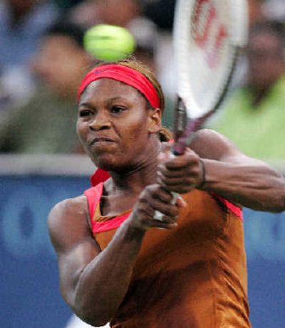 
Serena Williams returns a shot to Jelena Jankovic of Serbia. 
 (Associated Press / The Spokesman-Review)