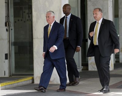 Secretary of State Rex Tillerson, left, and his security detail leave after a television interview with Chris Wallace, the anchor of “Fox News Sunday,” in Washington, Sunday, Aug. 27, 2017. (Susan Walsh / Associated Press)