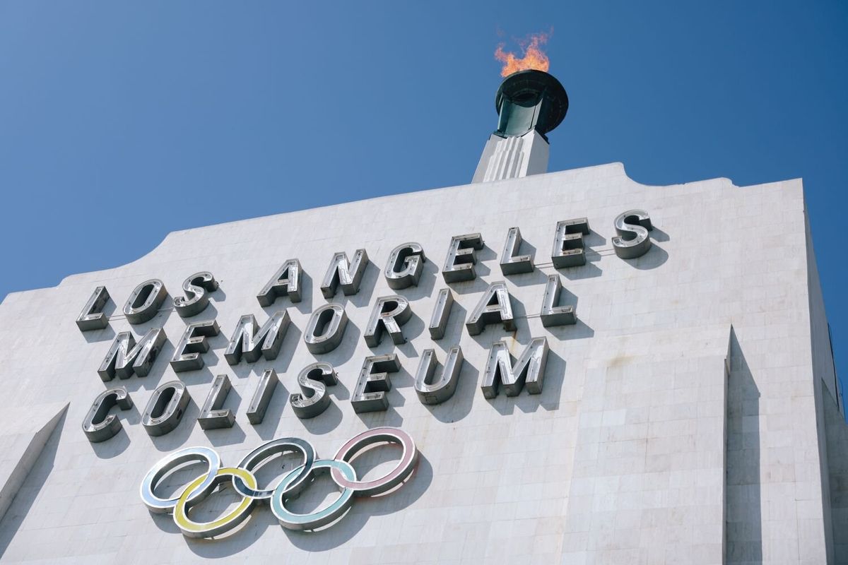 The torch is lit during an event to honor 1984 Los Angeles Olympic Organizing Committee President Peter V. Ueberroth at the Coliseum in 2022 in Los Angeles. He was presented with a plaque in the Coliseum