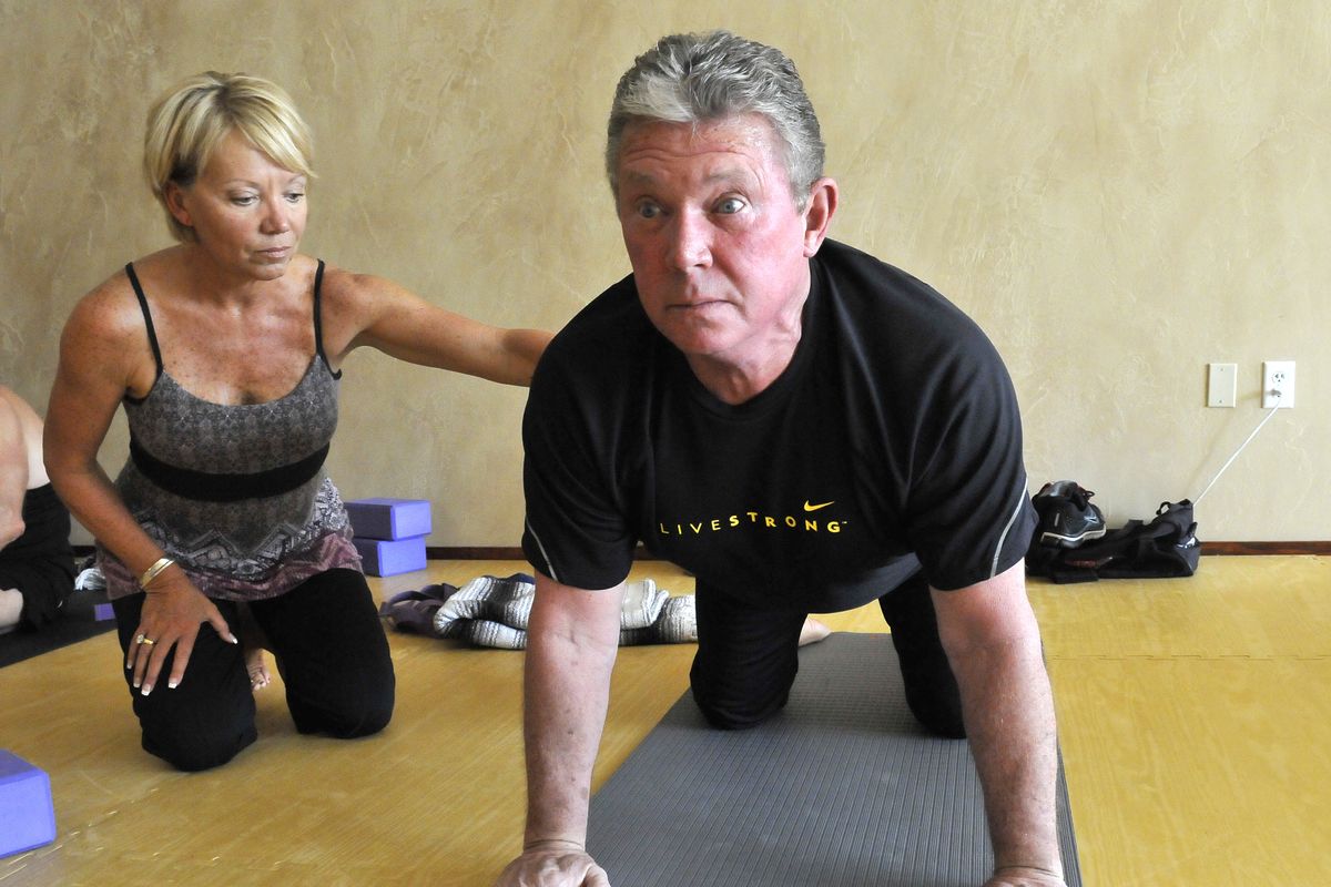 Bill Nichols gets some direction from yoga teacher Jan Long, left, before class Wednesday at The Mat, a studio in Liberty Lake. (Jesse Tinsley)