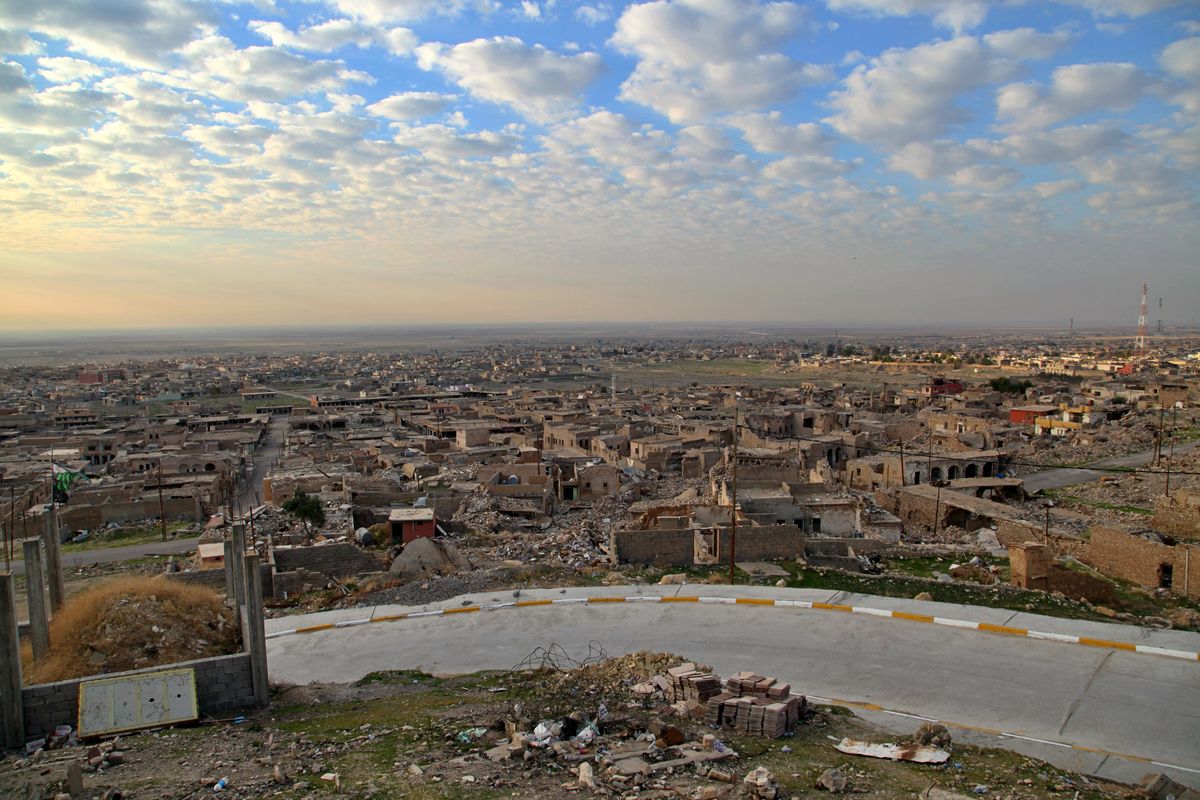 A view of deserted ruins in the northern Iraqi town of Sinjar, where the Iraqi army recently moved in to restore federal government control. Friday, Dec. 4, 2020. A new agreement aims to bring order to Iraq’s northern region of Sinjar, home to the Yazidi religious minority brutalized by the Islamic State group. Since IS’s fall, a tangled web of militia forces have run the area, near the Syrian border. Now their flags are coming down, and the Iraqi military has deployed in Sinjar for the first time in nearly 20 years.  (Samya Kullab)