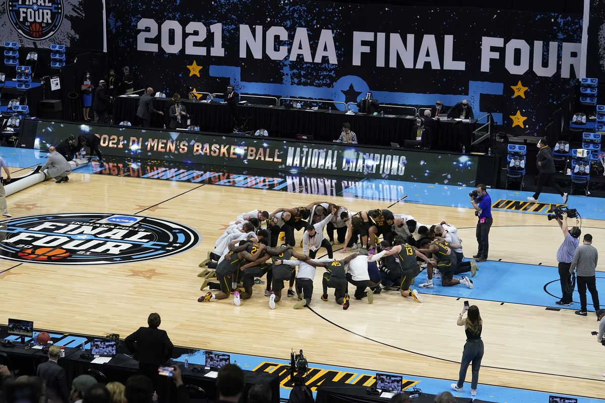 Baylor players huddle on the court at the end of the championship game against Gonzaga in the men