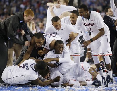 UConn players celebrate the school’s fourth NCAA men’s basketball championship since 1999 after their 60-54 victory over Kentucky. (Associated Press)