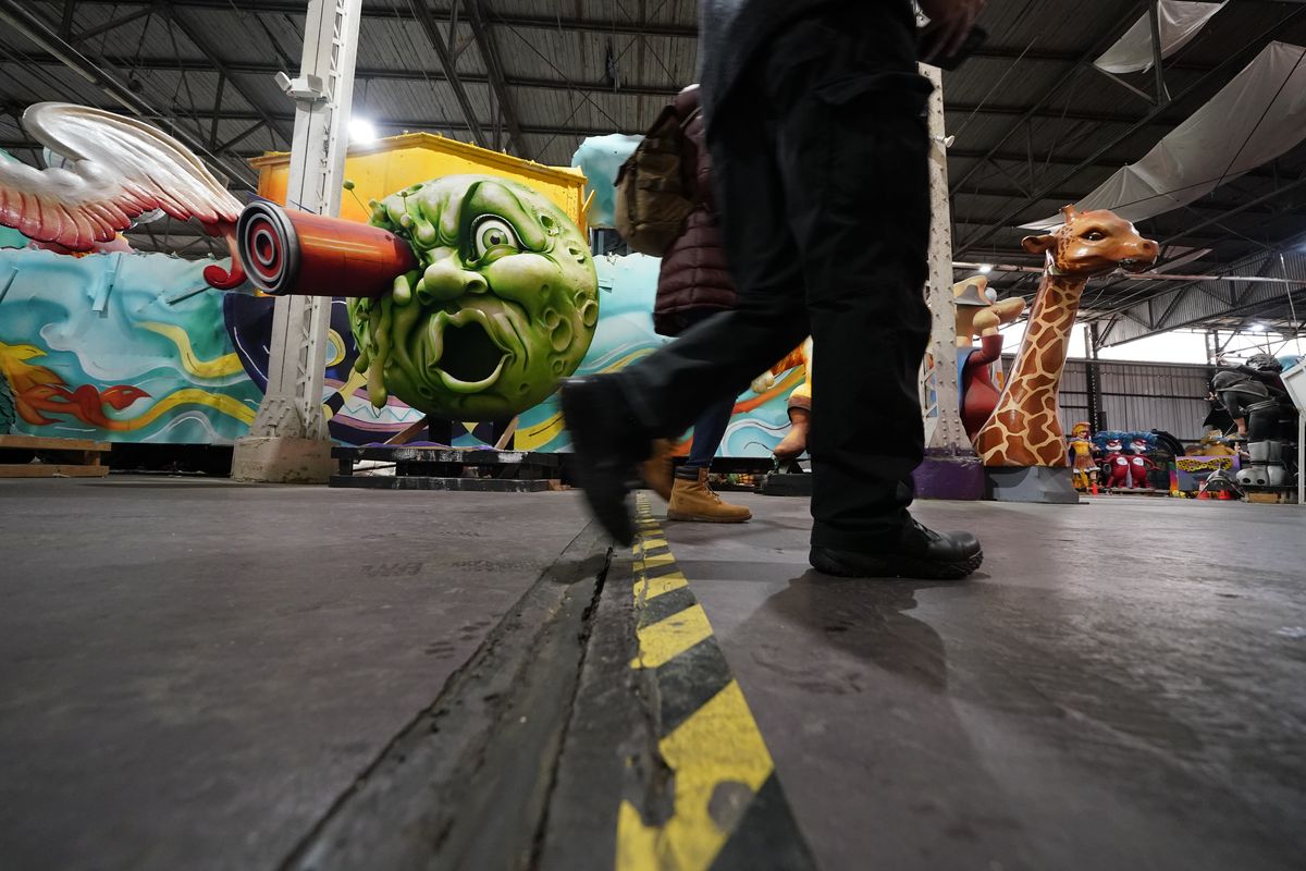 People walk by parts of Mardi Gras floats past and present Friday at Mardi Gras World, where Kern Studios creates and stores some of its floats in New Orleans.  (Gerald Herbert)