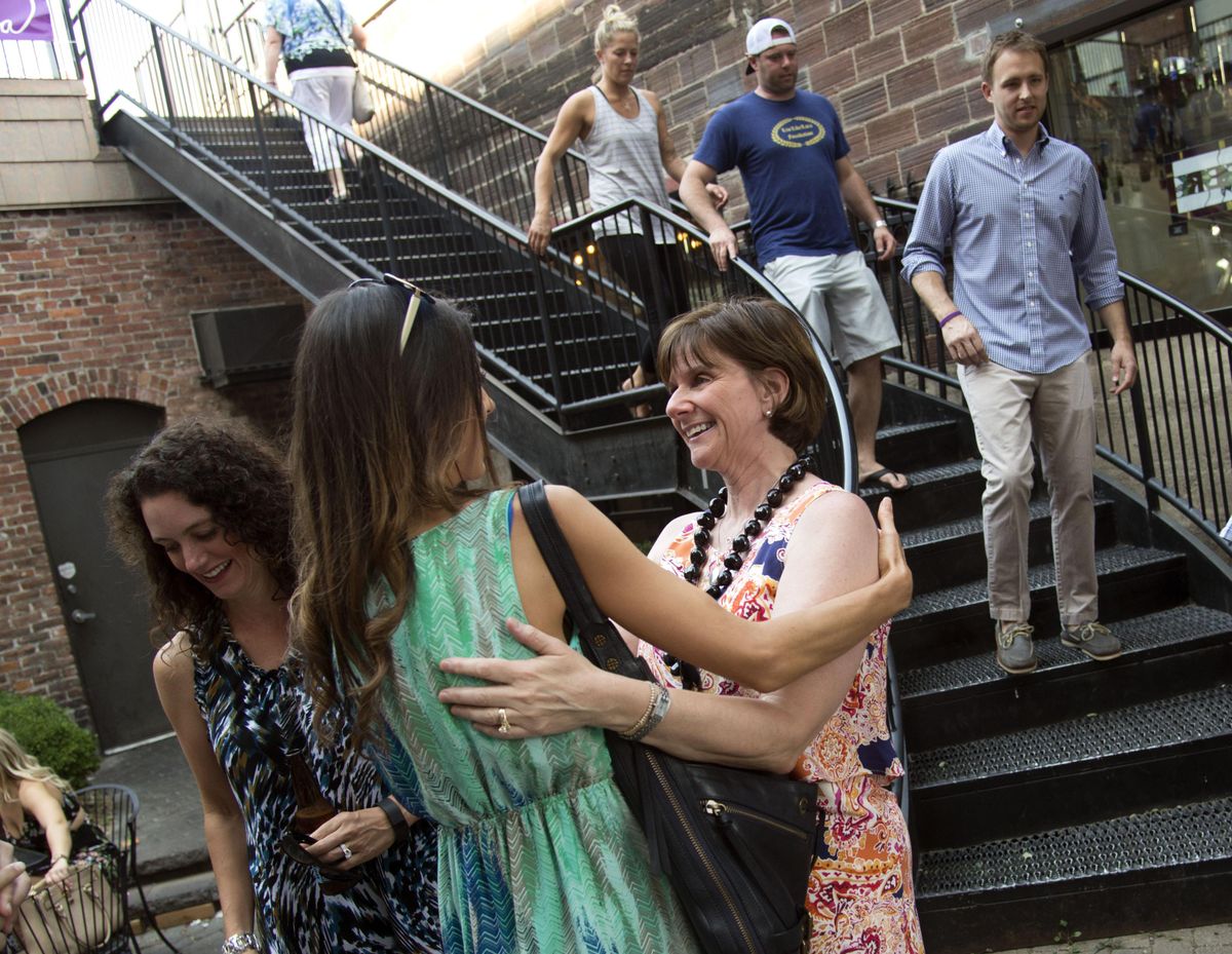 At the Live Like Lara Foundation fundraiser, Gerri Gass,  right, mother of Lara Gass, who was killed in a 2014 car accident, greets Rachel Speer at the Saranac Public House, Sat., Aug. 6, 2016. Speer was best friends with Lara since childhood. The event raised money for charities Lara Gass, a law student, cared about – Big Brothers and Sisters, Second Harvest and The Innocence Project. (Colin Mulvany / The Spokesman-Review)