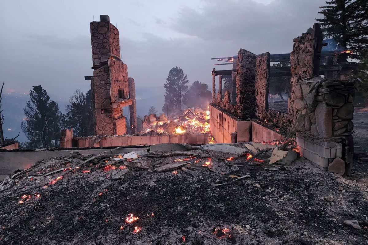 The remains of a home left after a wildfire spread through the Village of Ruidoso, New Mexico, on Wednesday, April 13, 2022. Officials say a wildfire has burned about 150 structures, including homes, in the New Mexico town of Ruidoso.  (Alexander Meditz)