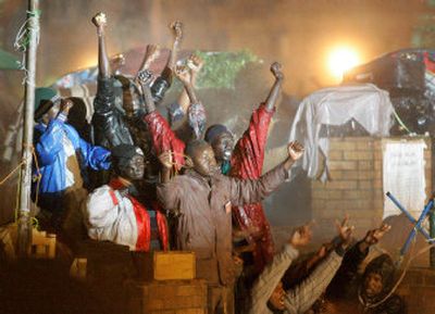 
Sudanese refugees react defiantly as Egyptian  troops fire water cannons on them before storming a camp housing hundreds of Sudanese in Cairo Friday. 
 (Associated Press / The Spokesman-Review)