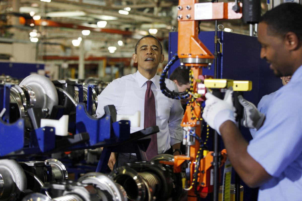 President Barack Obama watches a worker during a visit to the heavy duty engines line at the Daimler Detroit Diesel plant in Redford, Mich., Monday, Dec. 10, 2012. (Charles Dharapak / Associated Press)