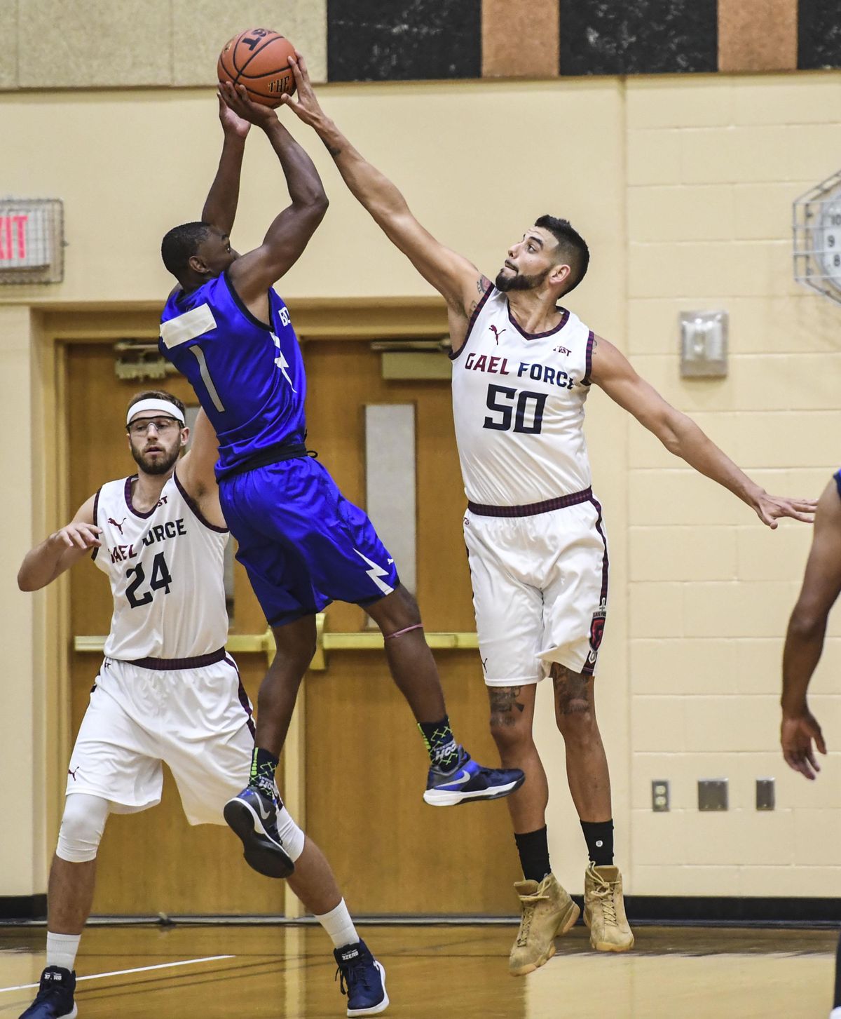 Gael Force center Omar Samhan (50) blocks a shot by Air Force Bomb Squad guard CJ Siples in the first quarter, Friday, June 29, 2018 at Lewis and Clark High School as part of The Basketball Tournament. Calvin Hermanson (24) is at left. (Dan Pelle / The Spokesman-Review)