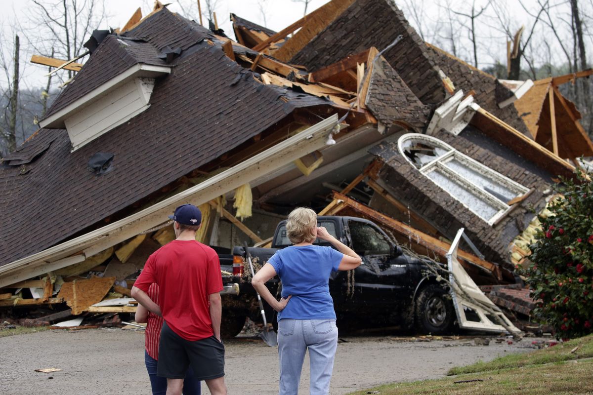 Residents survey damage to homes after a tornado touched down Thursday south of Birmingham, Ala.  (Butch Dill)