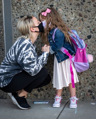 Lindsey Alice gives her nervous daughter Emme, 5, a goodbye kiss on the first day of in-class kindergarten instruction at Moran Prairie Elementary School on Wednesday.  (Colin Mulvany/THE SPOKESMAN-REVIEW)