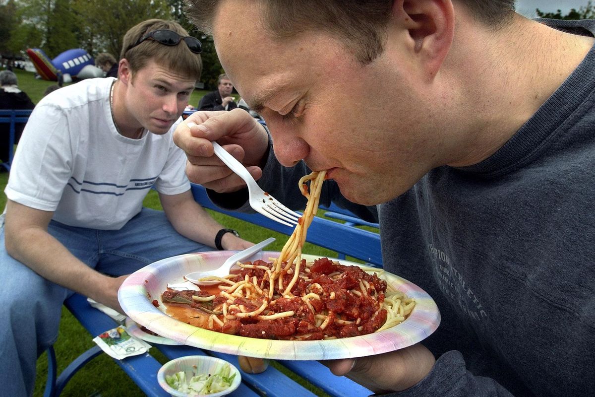 FILE – Brian Buchmann, slups up a mouthful of pasta at a spaghetti feed in Riverfront Park in May 2003. (Dan Pelle / The Spokesman-Review)