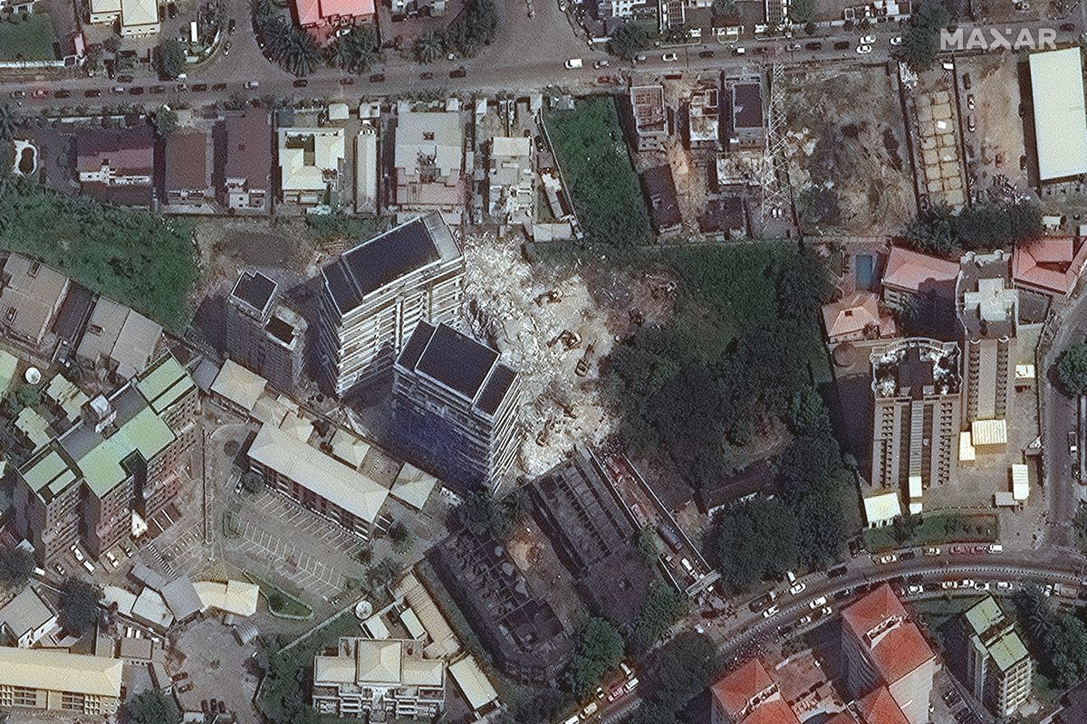 This satellite image provided by Maxar Technologies shows the close up of a collapsed building, center, in Lagos, Nigeria on Wednesday, Nov. 3, 2021. The 21-story luxury apartment building under construction toppled Monday and it took several hours for officials to launch the rescue effort. Authorities have arrested the property