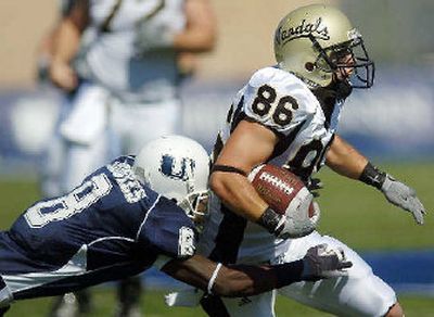 
Idaho's Lee Smith attempts to elude the tackle of  Drew Pearson Saturday. 
 (Associated Press / The Spokesman-Review)
