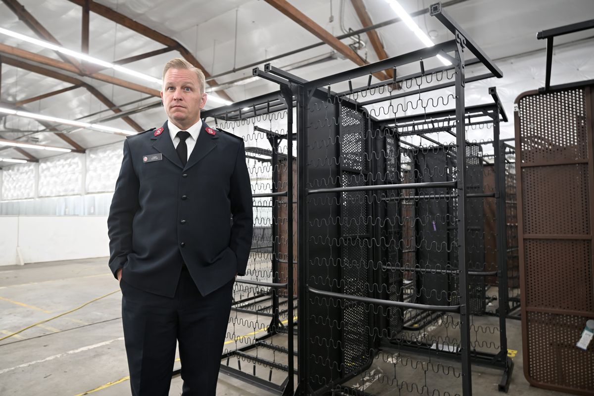 Captain David Corn of the Salvation Army stands near shelter beds piled up inside the Trent Resource Assistance Center shelter in east Spokane on Wednesday as the shelter prepares to shut down for good because of lack of city resources.  (Jesse Tinsley/THE SPOKESMAN-REVIEW)