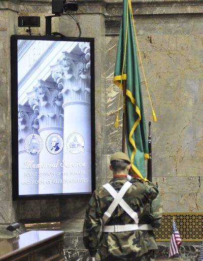 OLYMPIA -- A cadet honor guard carries the state flag to the Senate rostrum prior at the start of a memorial service for former Gov. Booth Gardner. (Jim Camden)
