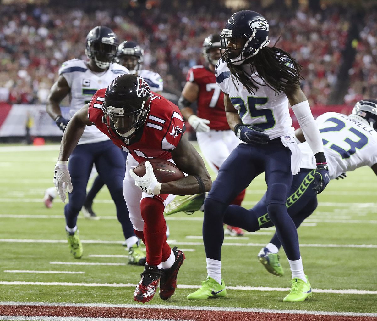 Atlanta Falcons wide receiver Julio Jones scores a touchdown past Seattle Seahawks cornerback Richard Sherman during the first quarter in an NFL football NFC divisional playoff game Saturday, Jan. 14, 2017, in Atlanta.  (Curtis Compton/Atlanta Journal-Constitution)